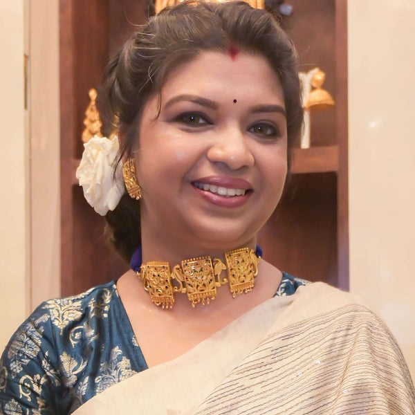 Woman wearing a stunning gold plated choker necklace and matching earrings, showcasing intricate design details.