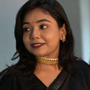 Elegant woman showcasing a gold plated choker necklace and matching earrings, perfect for special occasions.