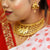 Gold plated butterfly charm bridal choker set and earrings worn by a woman in traditional attire.