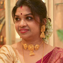 Elegant woman wearing gold-plated choker necklace and matching earrings, showcasing intricate design and traditional styling.